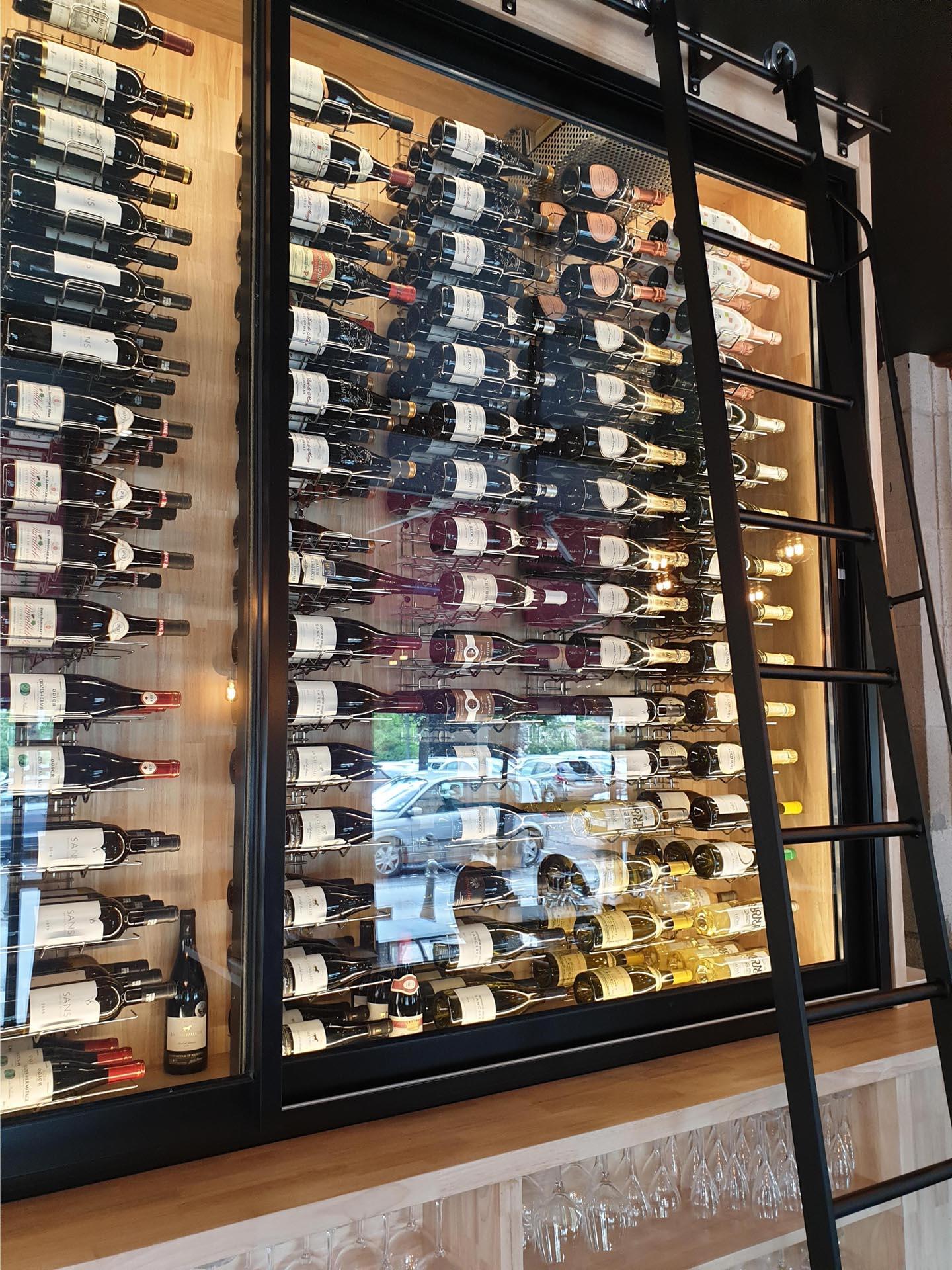Wine bottles arranged nicely inside a cabinet