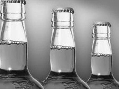 Black and white photo of beer bottle necks