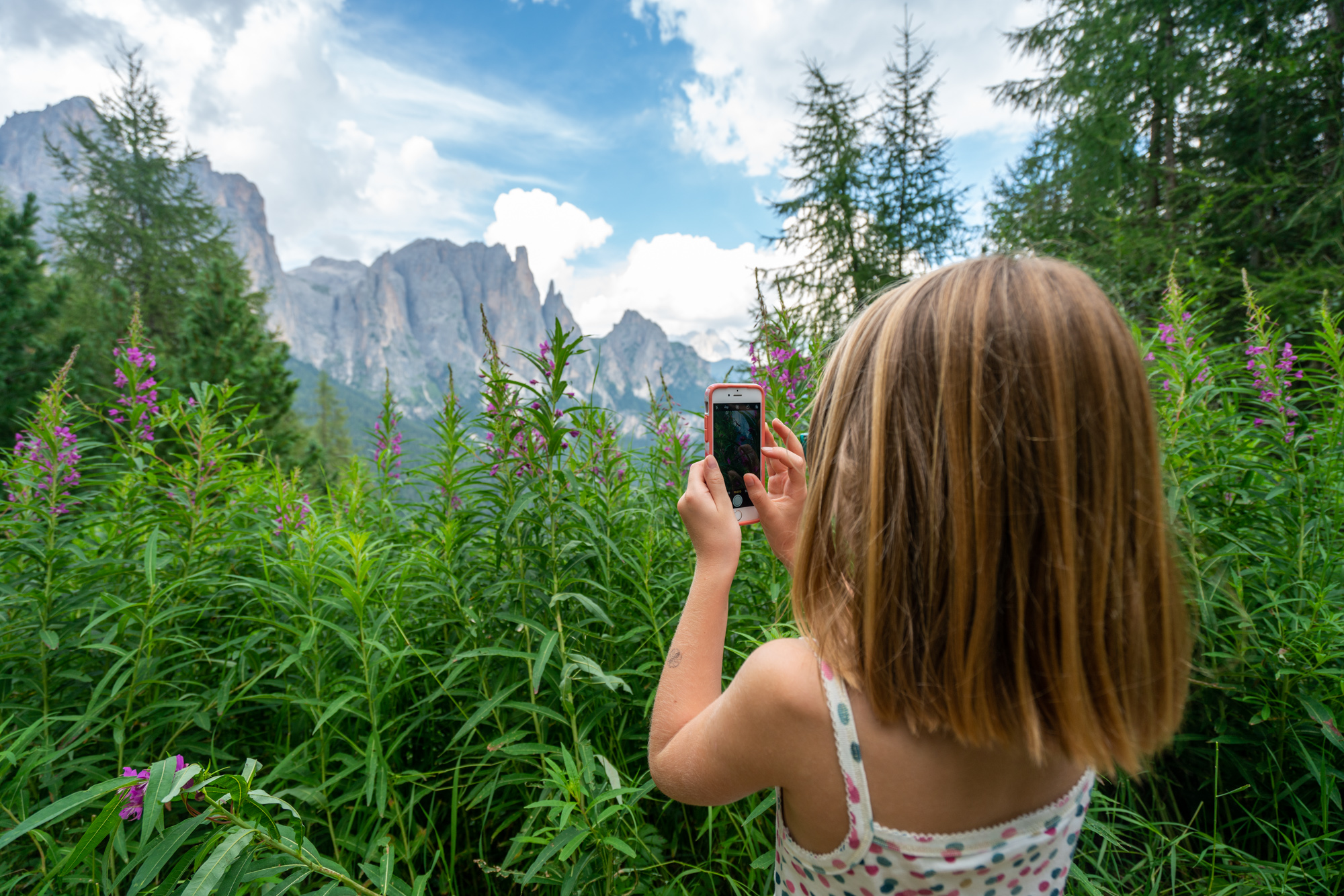 Girl taking pictures of Dolomites mountains near Fullerton Group