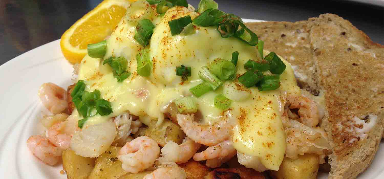 Eggs benedict with shrimp and hashbrowns. 