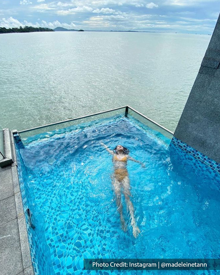 A woman enjoying her private pool at Lexis Hibiscus Resort