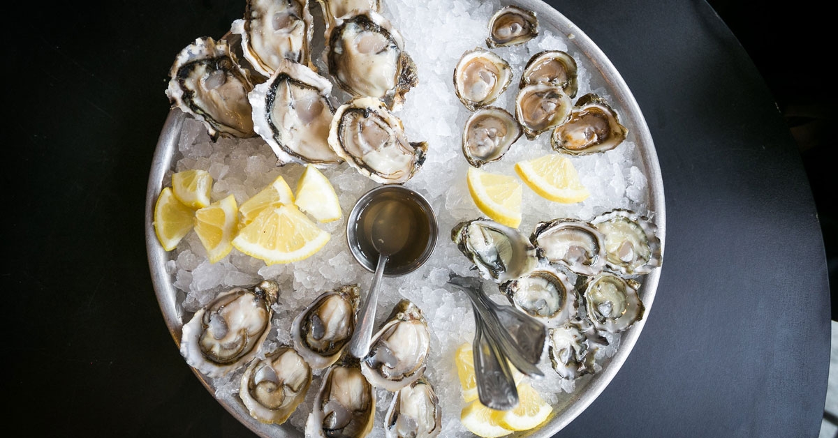 oysters on ice with lemons
