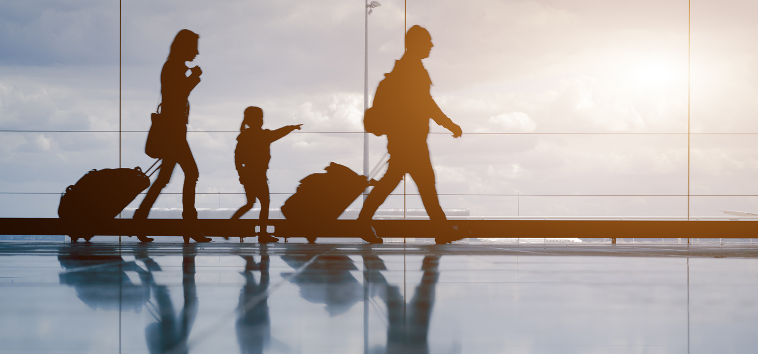 shadows of a family walking through an airport