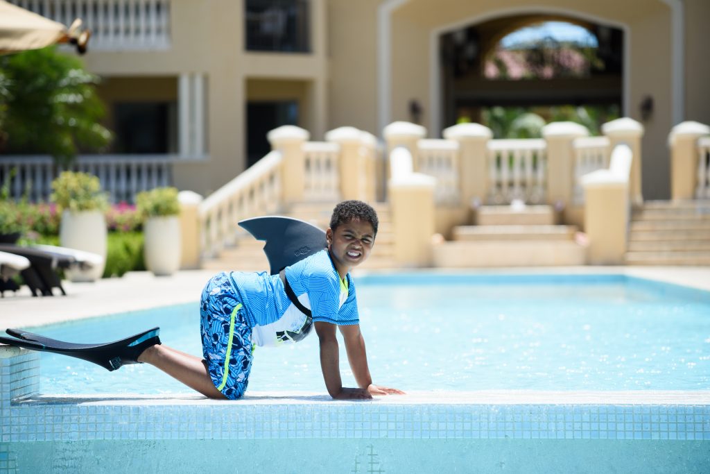 Boy facing for a photo at The Somerset on Grace Bay