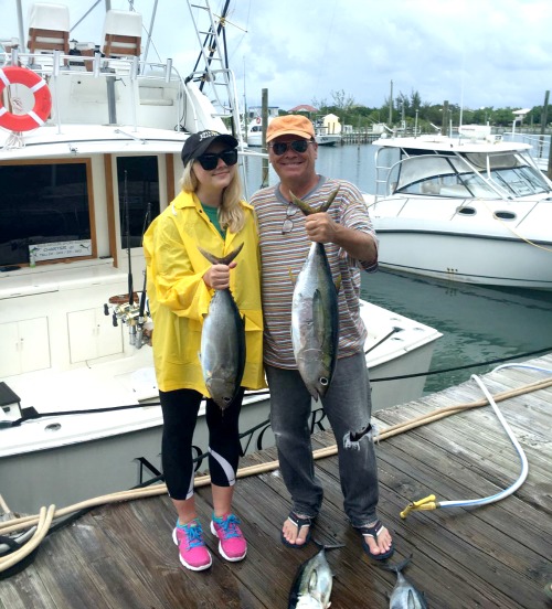 Father, daughter holding tuna fish, The Somerset On Grace Bay