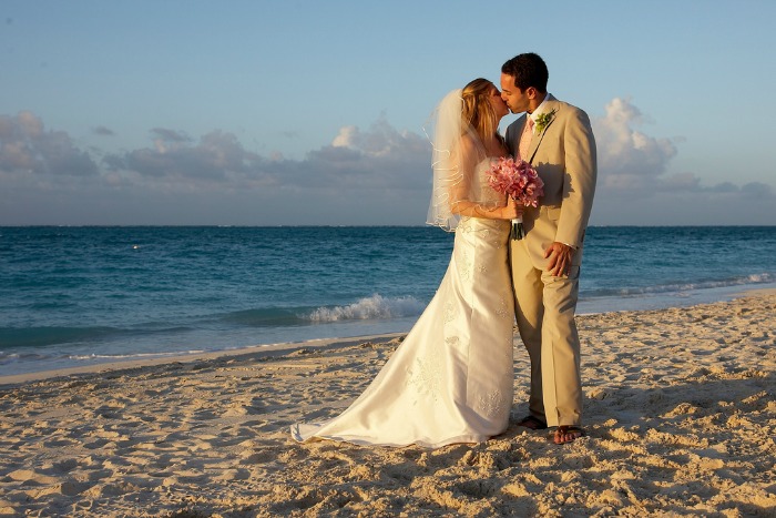 Couple kissing on the beach near The Somerset On Grace Bay