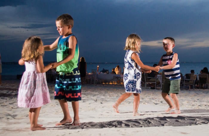 Kids dancing on the beach near The Somerset On Grace Bay