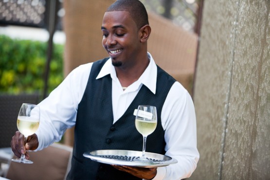Waiter serving champaign at The Somerset On Grace Bay