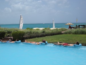 Tourists sun bathing in the pool, The Somerset on Grace Bay