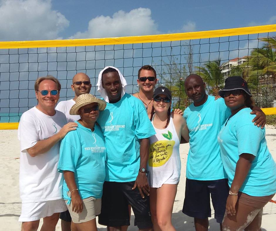 Volleyball players posing on beach at The Somerset on Grace Bay