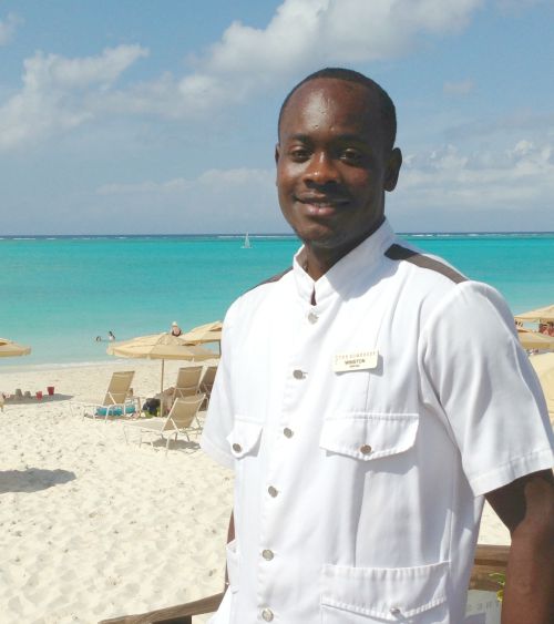Bellman posing on the beach at The Somerset on Grace Bay