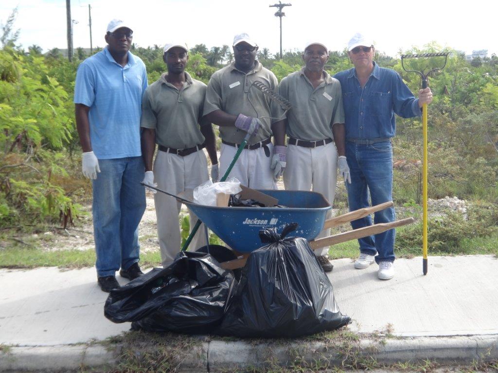 Men collecting garbage in a wheel barrow, Somerset on Grace Bay