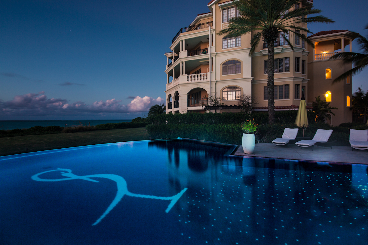 Pool at night with two sunbeds at The Somerset on Grace Bay