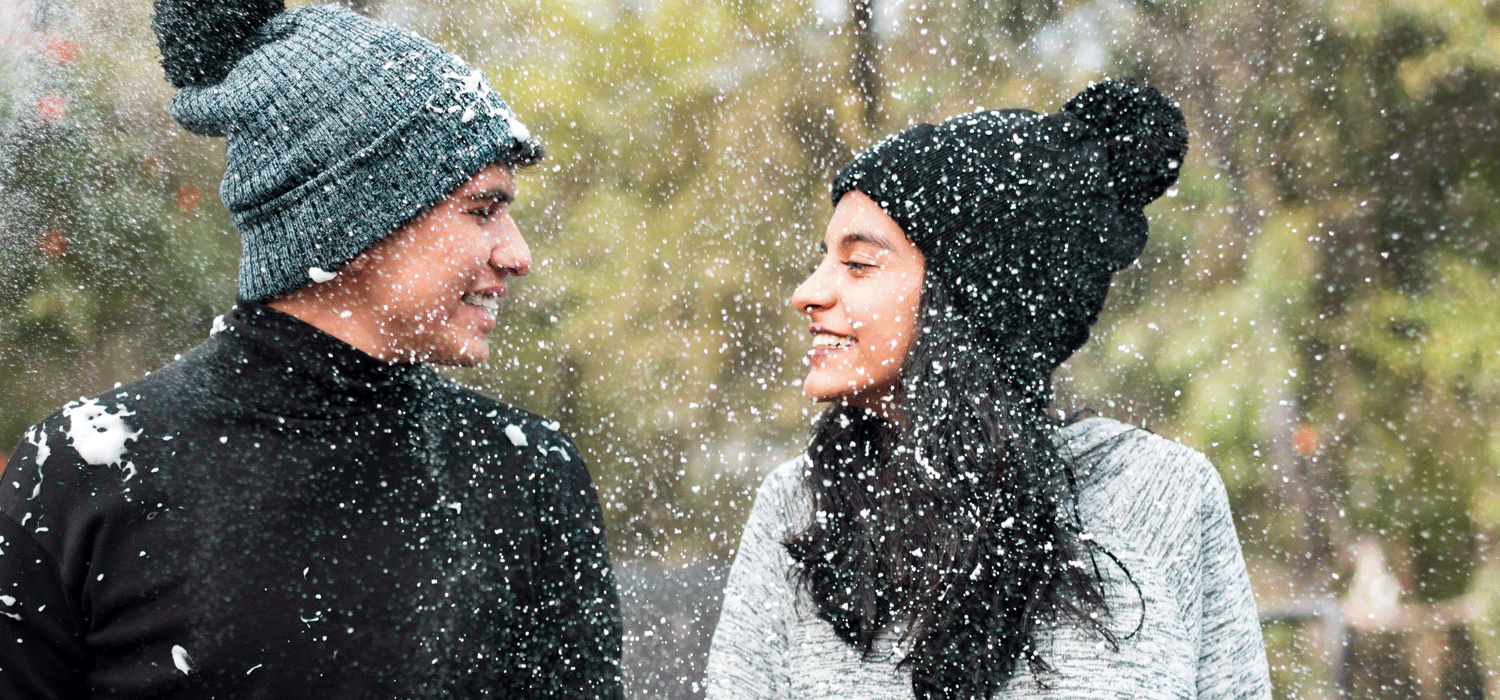 couple standing in the snow